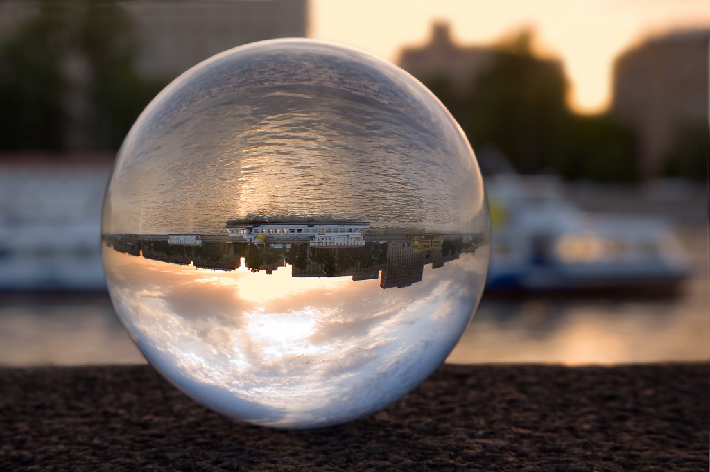 Russia, Moscow river, sunset. In a glass sphere the turned ship floating is visible